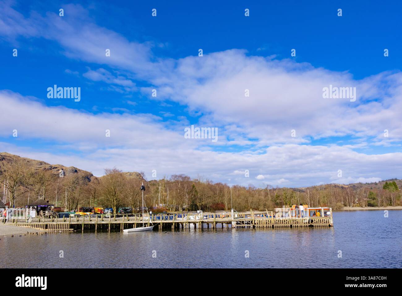 Water Head pier wooden jetty with boats on Coniston Water in English Lake District National Park. Waterhead, Coniston, Cumbria, England, UK Stock Photo