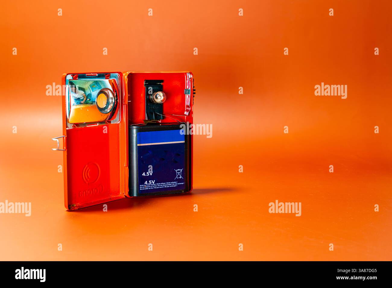 Open antique lantern on an orange background Stock Photo