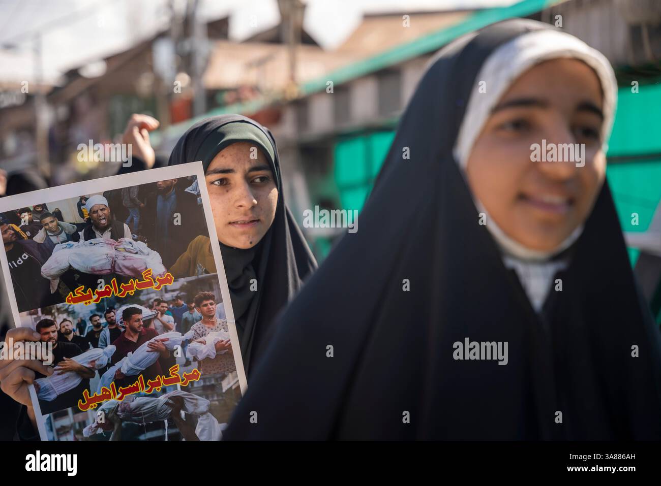 A Muslim woman holds a placard during a rally marking Quds Day ...
