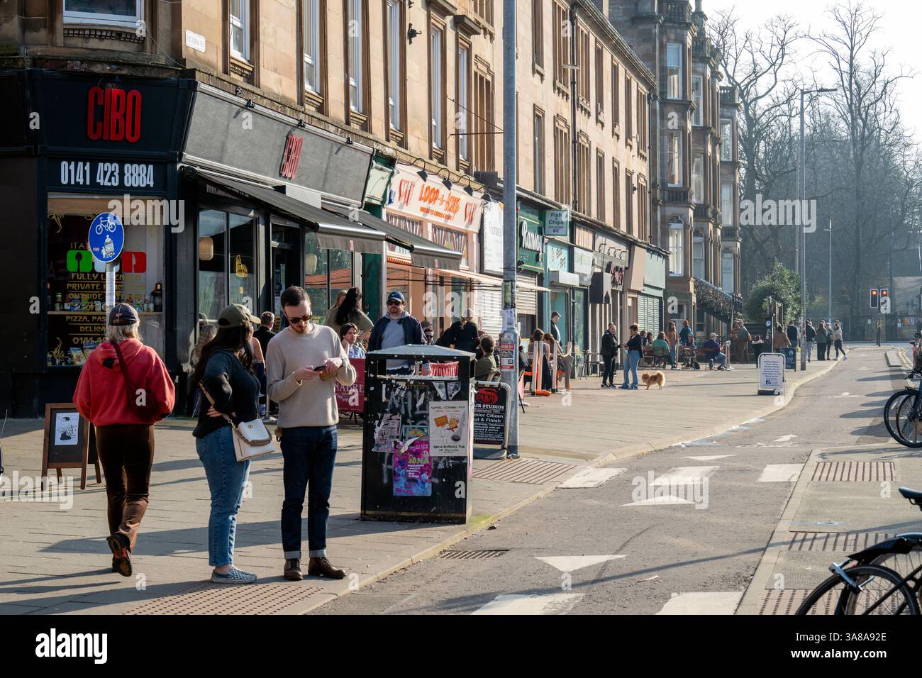 A bustling Victoria Road in the Govanhill area of Glasgow's Southside. Gentrification of a once poor working class neighbourhood . Stock Photo
