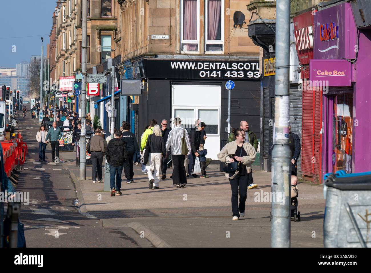 A bustling Victoria Road in the Govanhill area of Glasgow's Southside. Gentrification of a once poor working class neighbourhood . Stock Photo