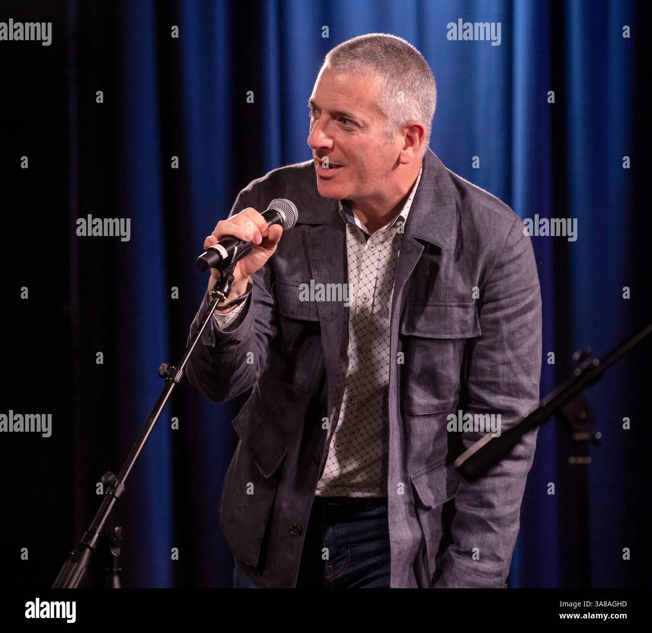 Steven Jenkins, director of the Bob Dylan Center and archive, poses for a  photo at the archive wall, Thursday, May 5, 2022, in Tulsa, Okla. The  center offers an immersive film experience,, image size:1300x1261
