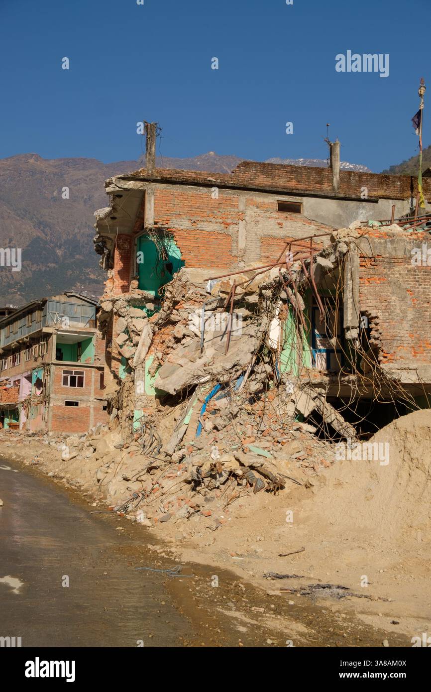 A Building Lies Severely Damaged Likely From An Earthquake Rubble And