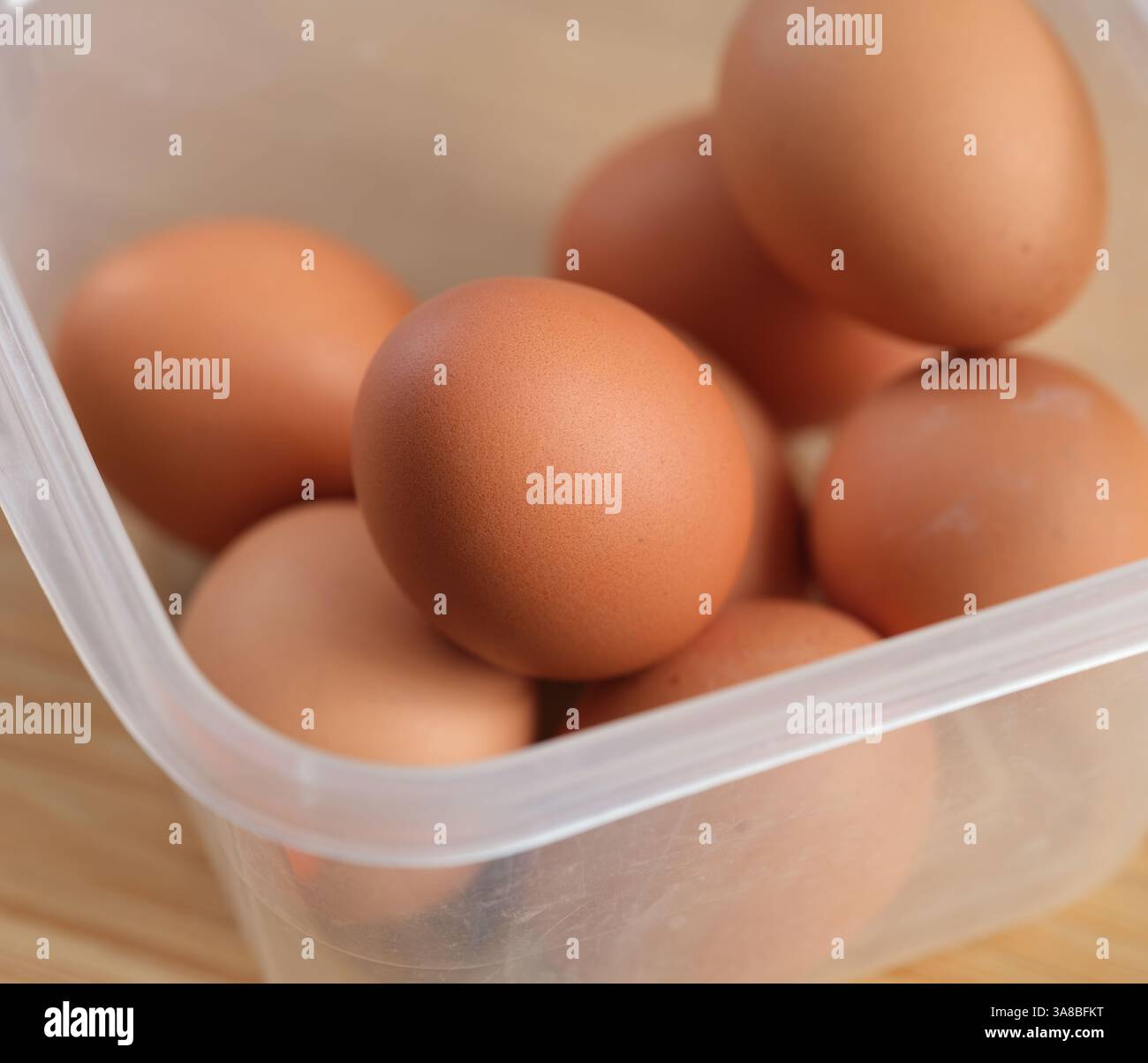 Brown hard boiled eggs in a plastic container. Close up. Stock Photo