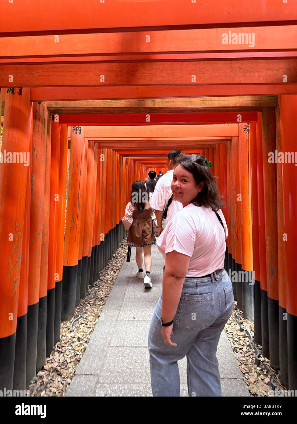 Woman in Kyoto red tori gates - Smartphone Captured Stock Image