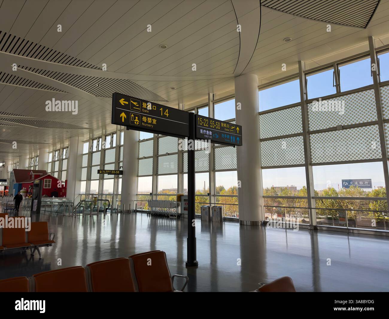 Yinchuan, China - Nov 3, 2023: Inside Yinchuan Hedong International Airport, with signs and seating. - Smartphone Captured Stock Image