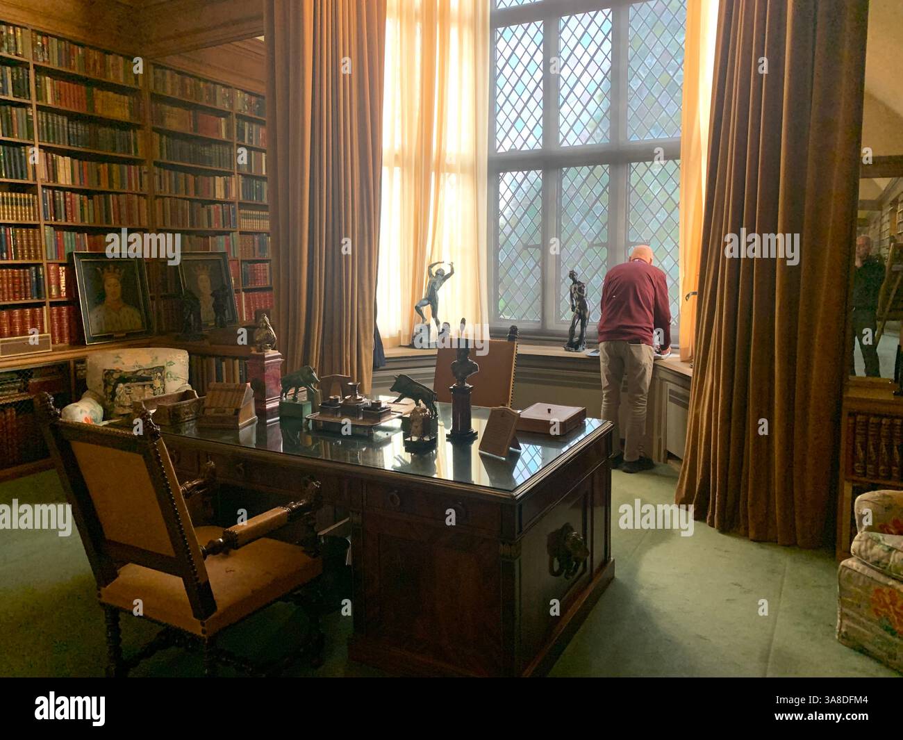 Anglesey Abbey Cambridgeshire UK England hall dog lights stand pictures carpets carpet decorations library Mary Queen of Scots Henry the eighth - Smartphone Captured Stock Image