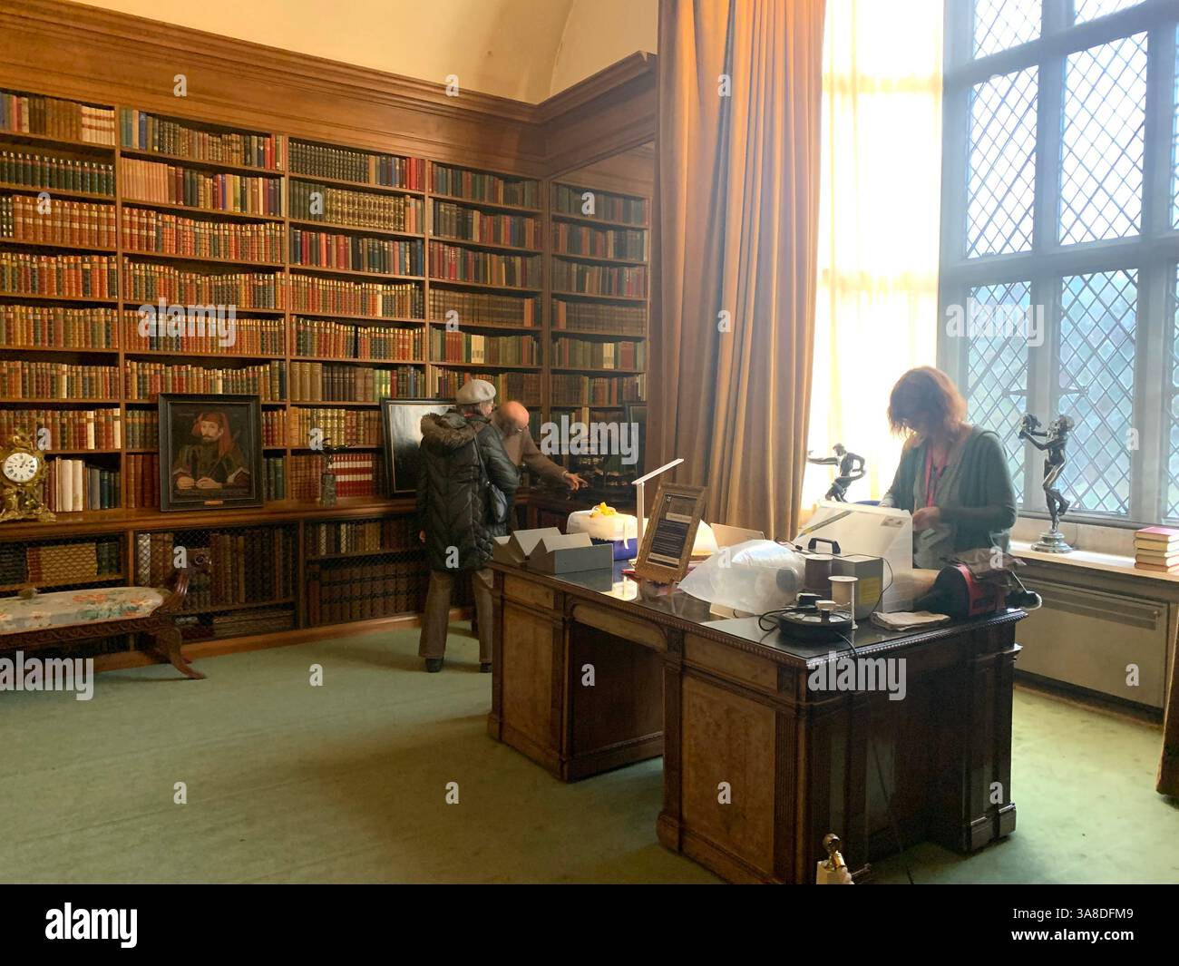 Anglesey Abbey Cambridgeshire UK England hall dog lights stand pictures carpets carpet decorations library Mary Queen of Scots Henry the eighth - Smartphone Captured Stock Image