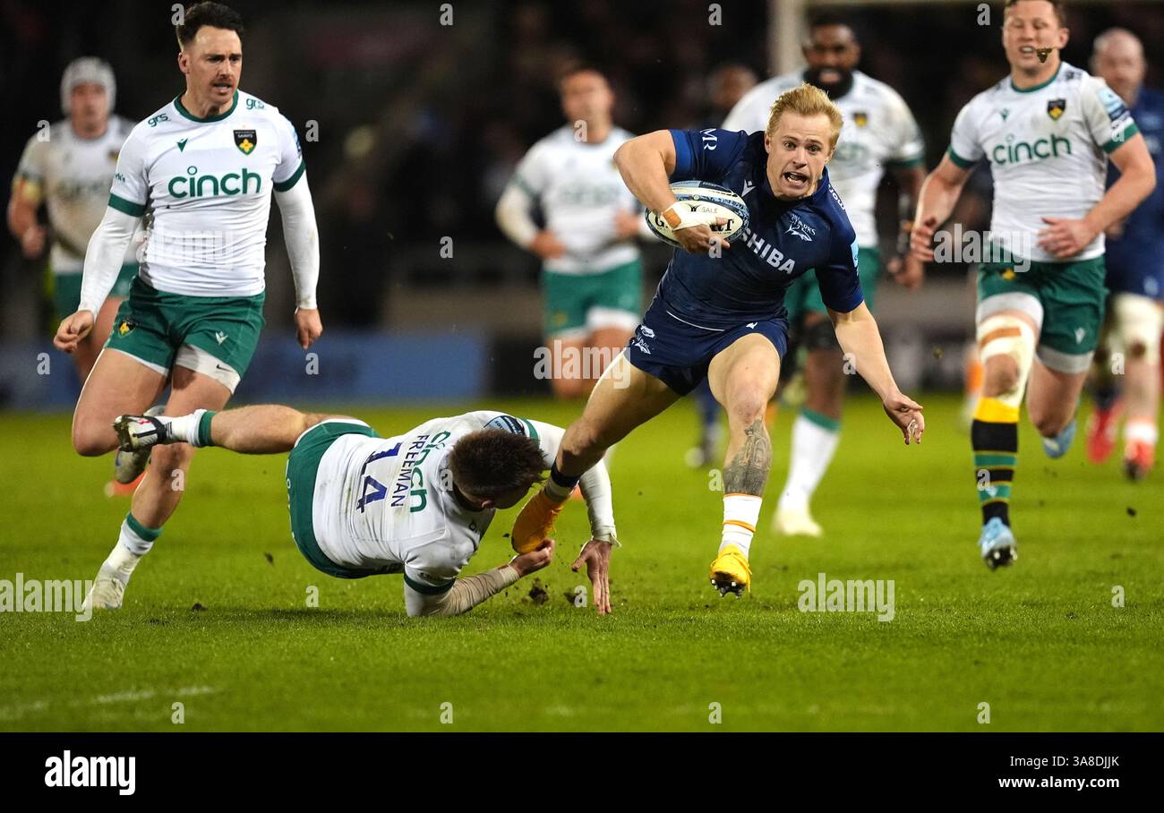 Sale Sharks' Arron Reed is tackled by Northampton Saints' Tommy Freeman ...