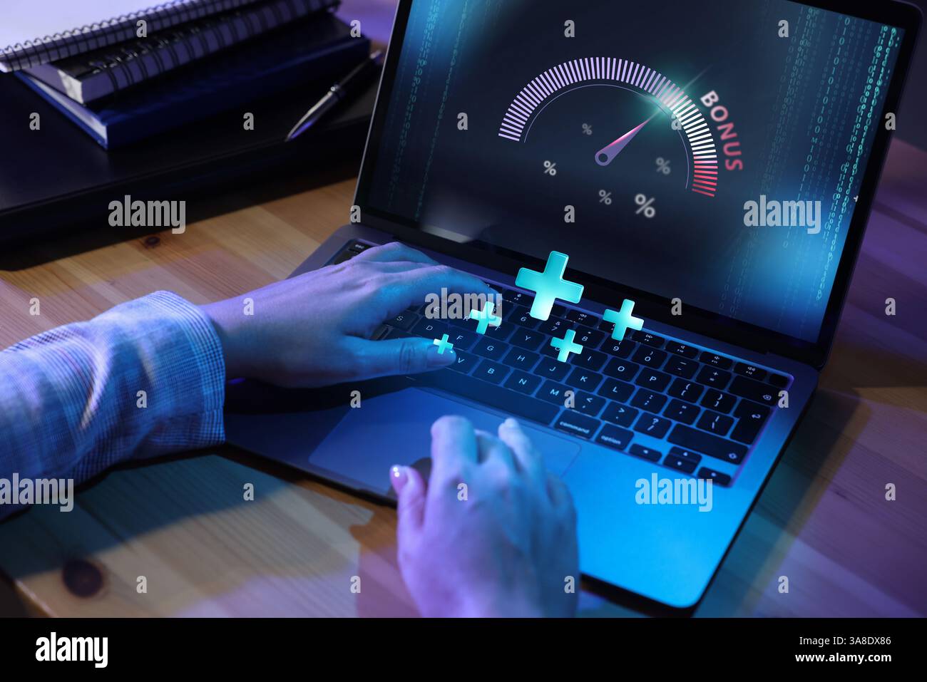 Bonus. Woman using laptop with gauge and percent signs on screen at table, closeup. Pluses over computer Stock Photo