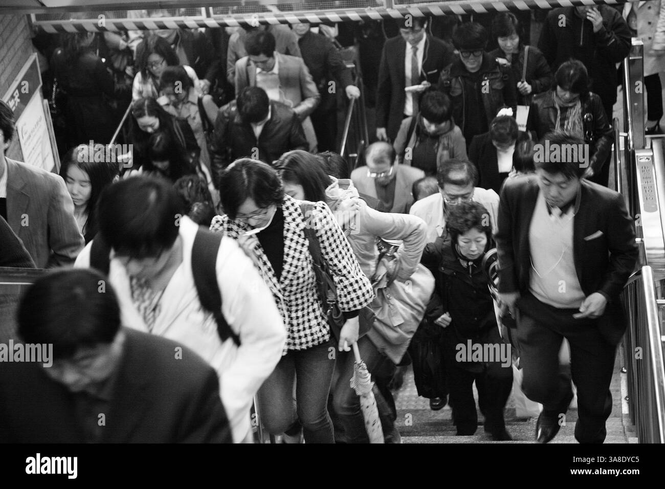 SEOUL, SOUTH KOREA. 26 APRIL, 2011. Commuters rush up the stairs at a crowded Seoul subway station during the morning rush hour. Stock Photo