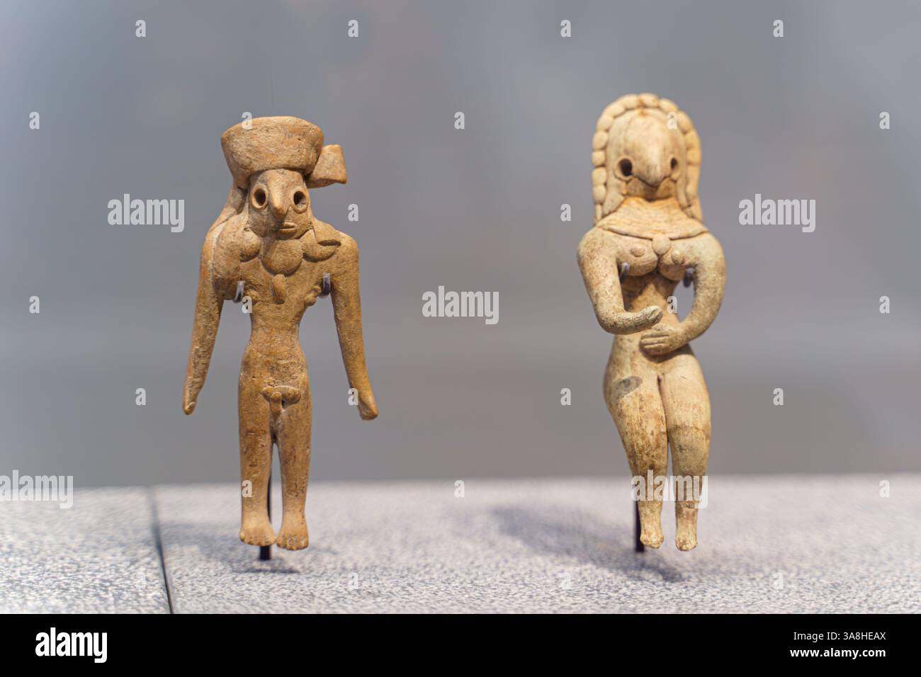 Abu Dhabi, United Arab Emirates - Jan 17 2024, Close-up view of two ancient statuettes of women, deities, with necklace, on exhibition of museum Louvr Stock Photo