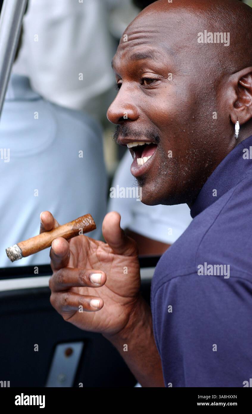 Retired NBA All-Star Michael Jordan prepares to lite his cigar as he walks  off the first tee of the 2005 Mellon Mario Lemieux Celebrity Invitational  at the Club at Nevillwood near Pittsburgh
