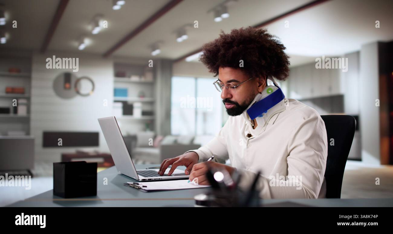 Injured Worker Compensating for Broken Arm by Working from Home Stock Photo