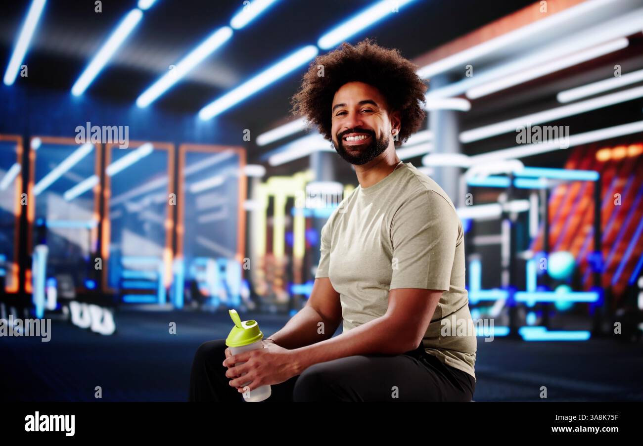Young African American athlete taking break, refreshing with water bottle. Stock Photo