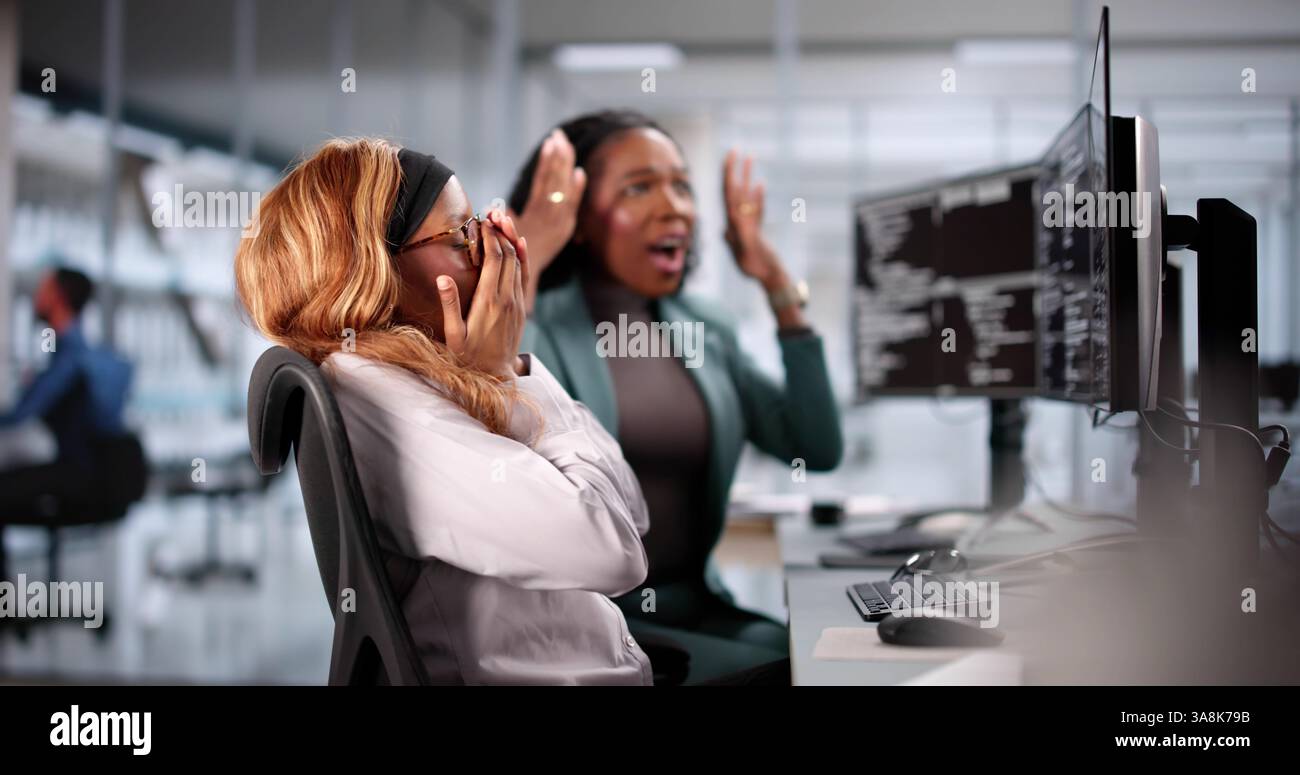 Unhappy developer stressed coding software on computer in office. Frustrated. Stock Photo