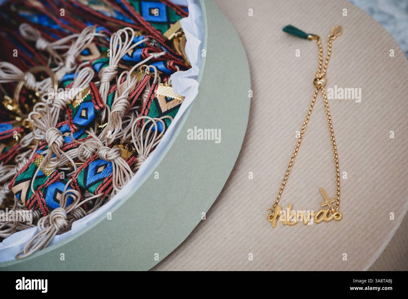 A small bracelet for the godmother to wear, and more small ornaments for the guests to wear, during a greek orthodox baptism Stock Photo