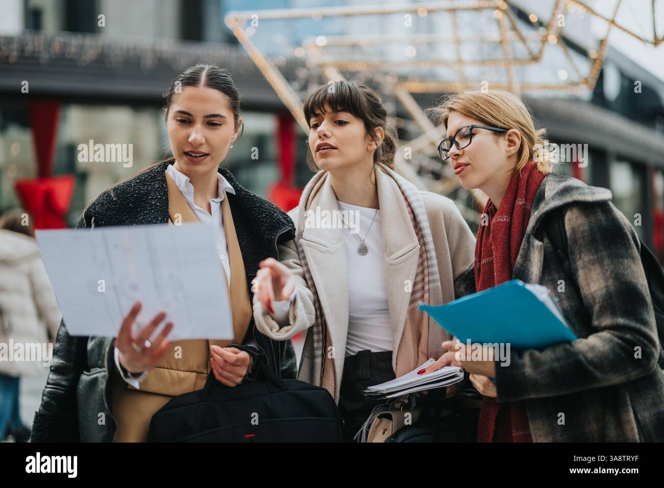 Three Professionals Collaborating Three professional businesswomen collaborating and discussing ...