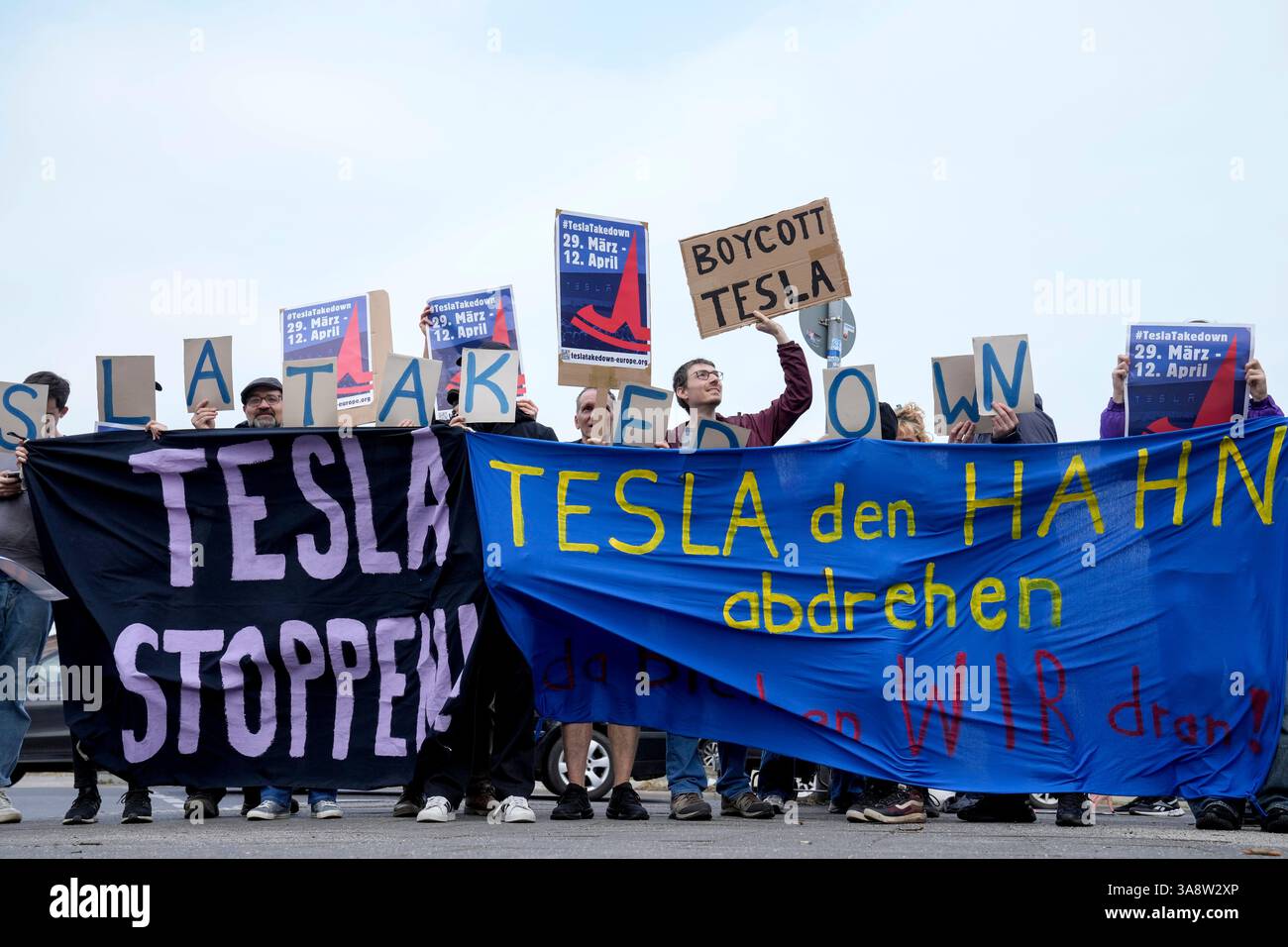 Protesters attend the Tesla Takedown Global Day of Action in front of a ...