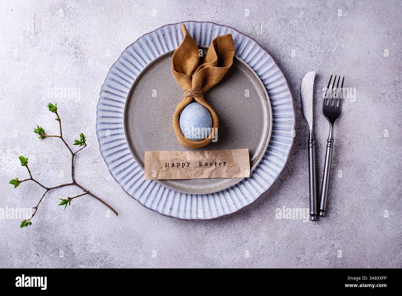 Elegant Easter table setting with painted egg Stock Photo