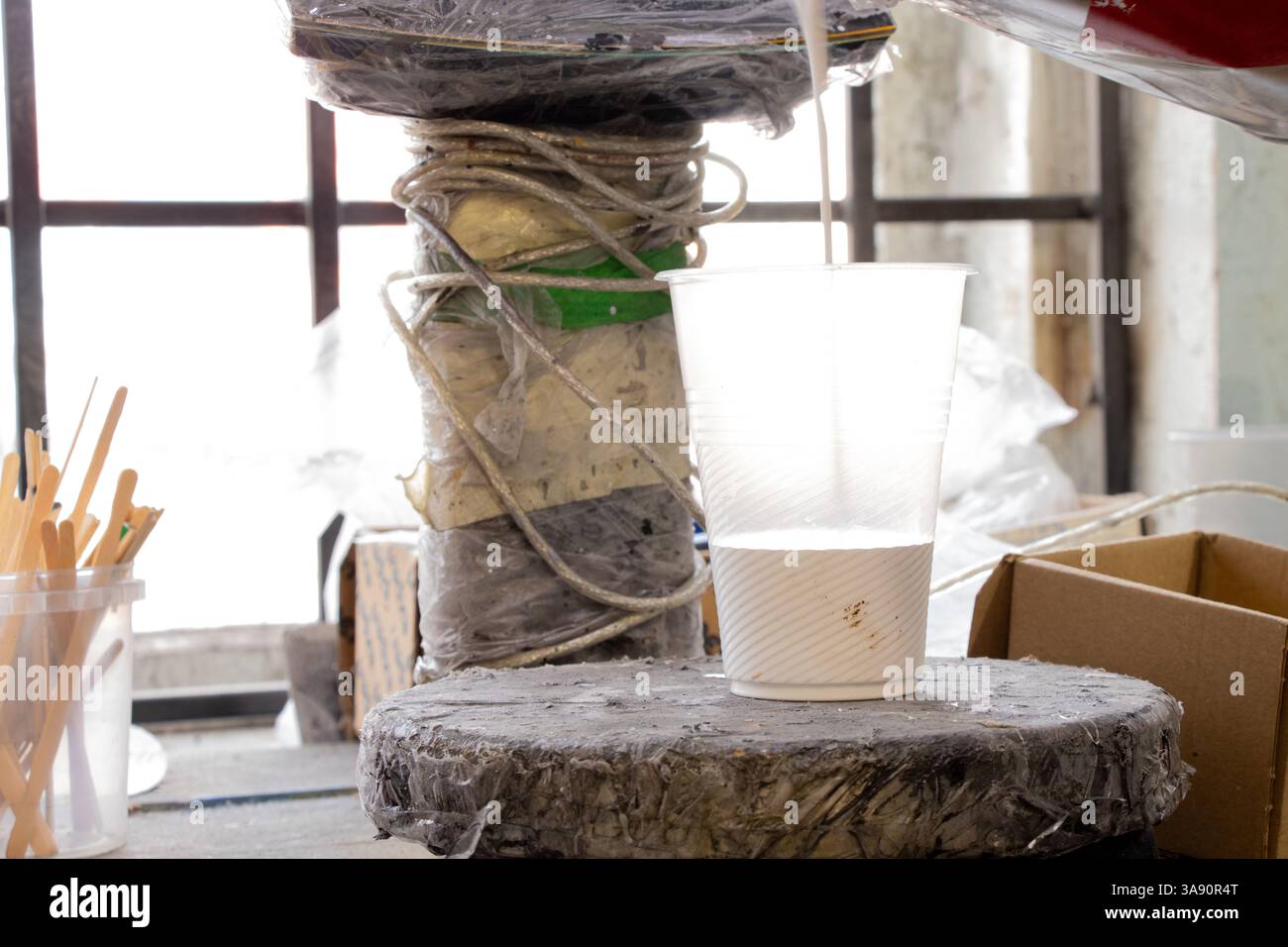 An artist weighs paint on scales for further painting in the studio, preparing paint for painting Stock Photo