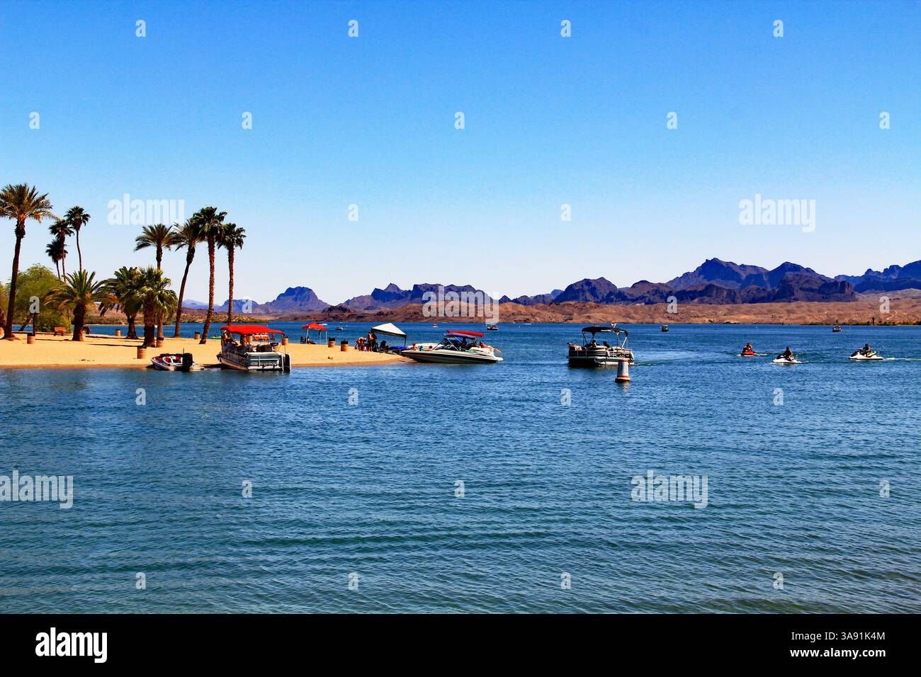 Tourists And Mountains Across Lake Havasu On The Bridgewater Channel In 