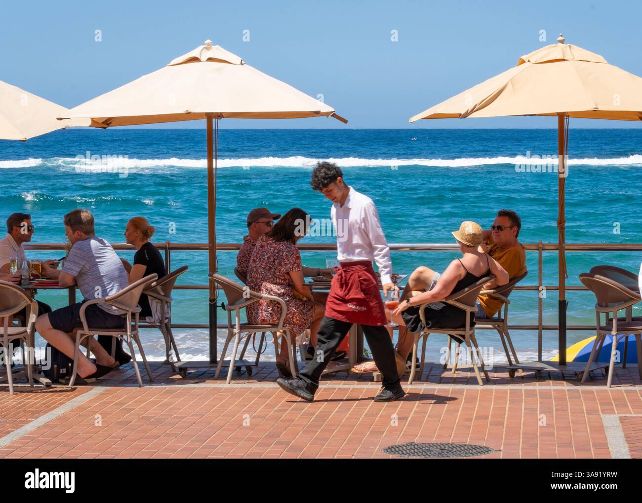 Gran Canaria, Canary Islands, Spain, 29th March 2025. Tourists, many British and German, bask in glorious sunshine on a packed city beach in Las Palmas as temperatures reach 30 degrees Celcius. Credit: Alan Dawson/Alamy Live News. Stock Photo
