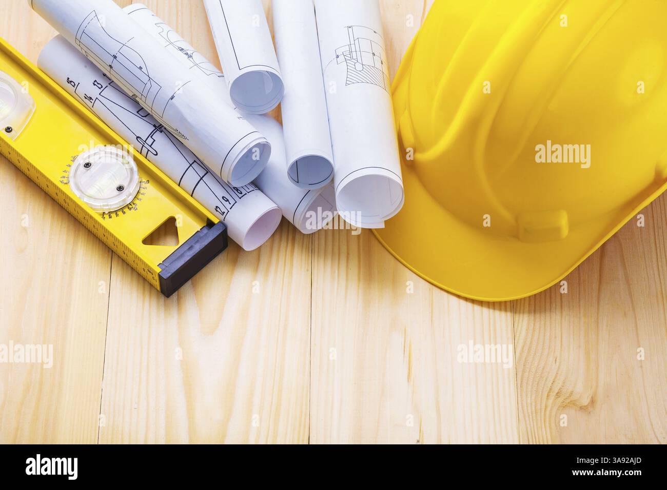 Helmet construction level and blueprints on wooden boards Stock Photo ...