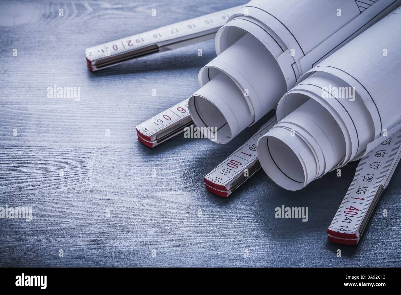 Two rolls of blueprints on white wooden meter Stock Photo - Alamy