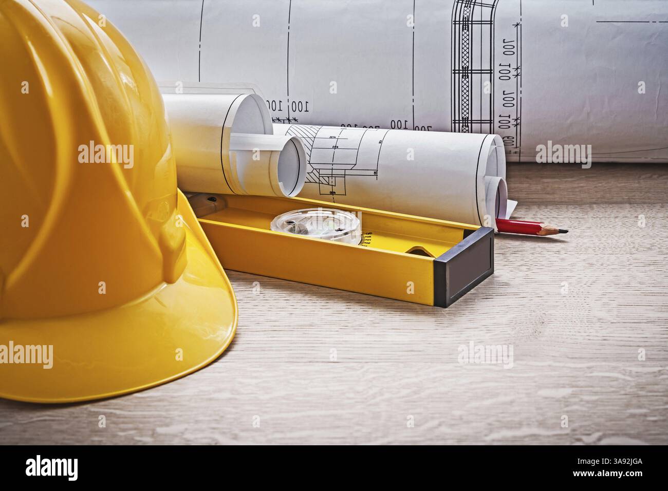 Very close up view on blueprints level and construction helmet Stock ...