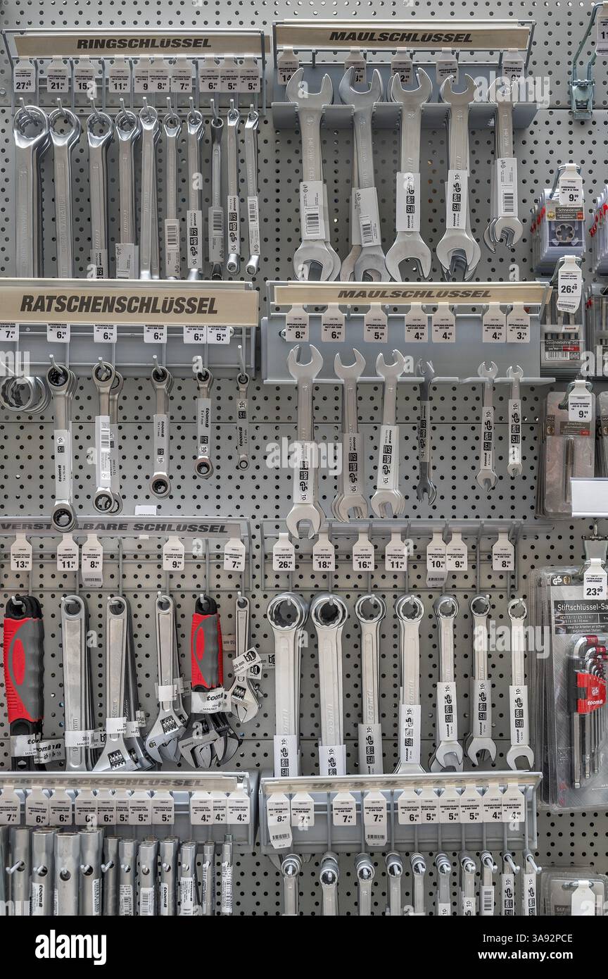 Wall with open-end, socket, ratchet and ring spanners in a DIY store ...