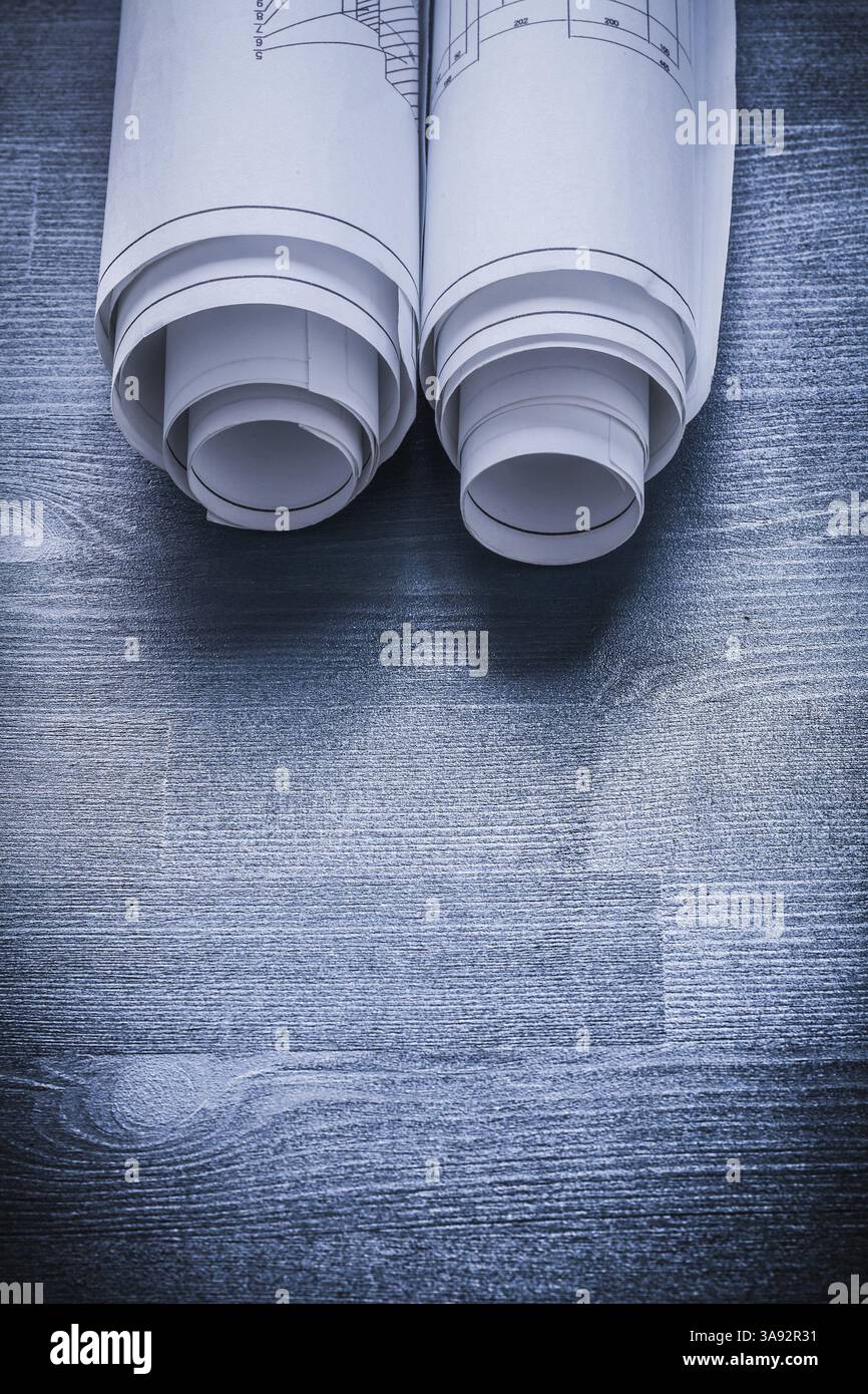 Vertical view white rolled up blueprints on blue painted board Stock ...