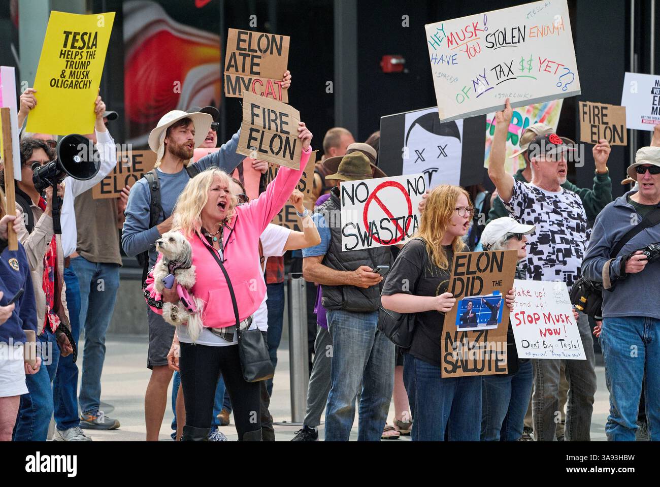Protesters rally during a protest outside a Tesla showroom against U.S ...