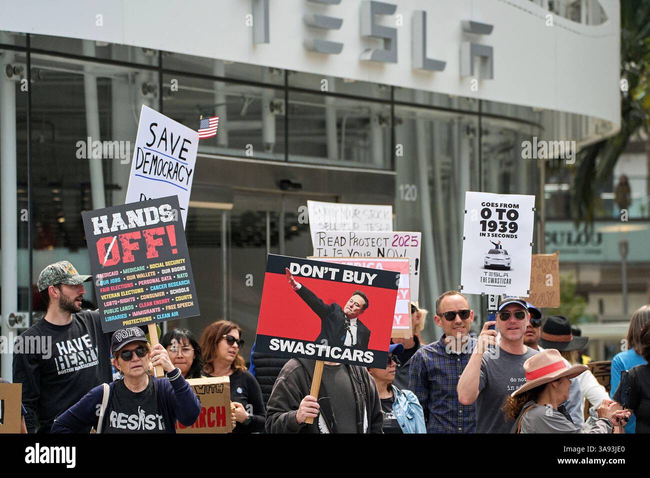 Protesters rally during a protest outside a Tesla showroom against U.S ...