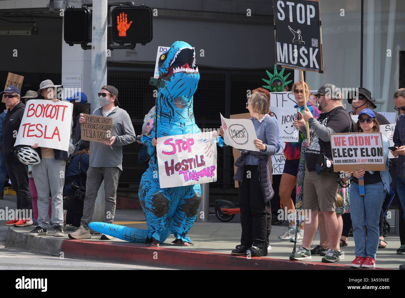 Protesters rally during a protest outside a Tesla showroom against U.S ...