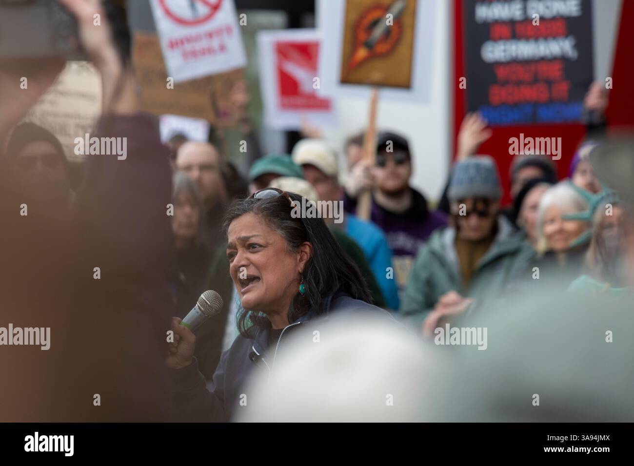 Seattle, Washington, USA. 29th March, 2025. U.S. Representative Pramila Jayapal speaks passionately to protesters during a rally at University Village Tesla. The Tesla Takedown Rally, part of a Global Day of Action, is a protest against Elon Musk and the Donald Trump administration. Credit: Paul Christian Gordon/Alamy Live News Stock Photo