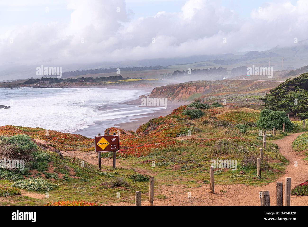 Cambria, CA, USA: March 27, 2025: A posted danger sign along the ...