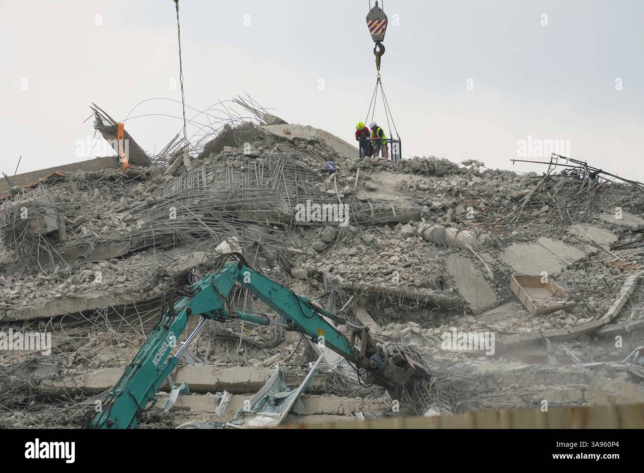 Rescuers works look for the survivors at the site of an under ...