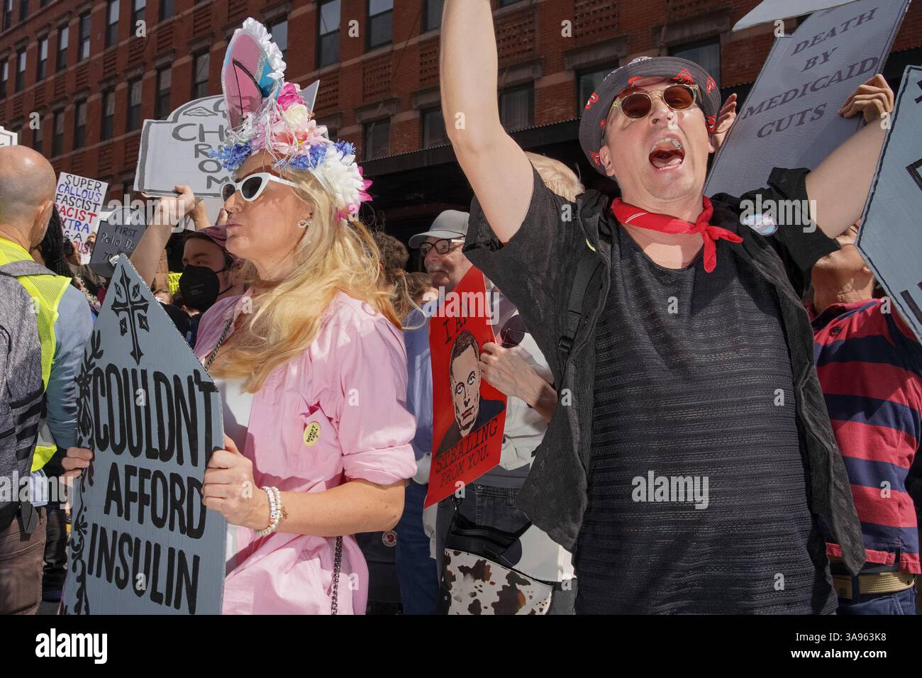 People hold up tombstone signs during the'TeslaTakedown' protest ...