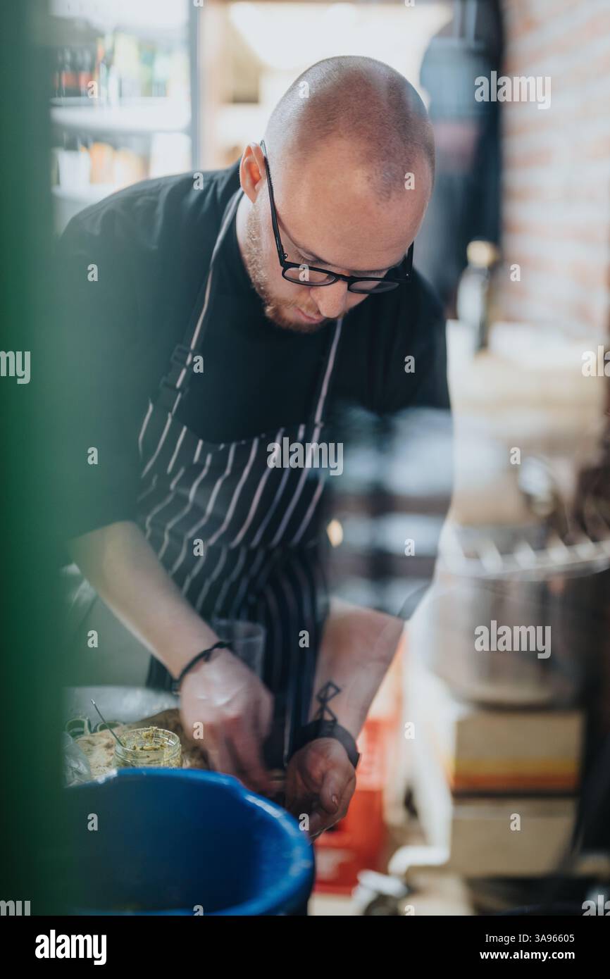 Chef preparing dishes in professional kitchen during a dedicated cooking session Stock Photo