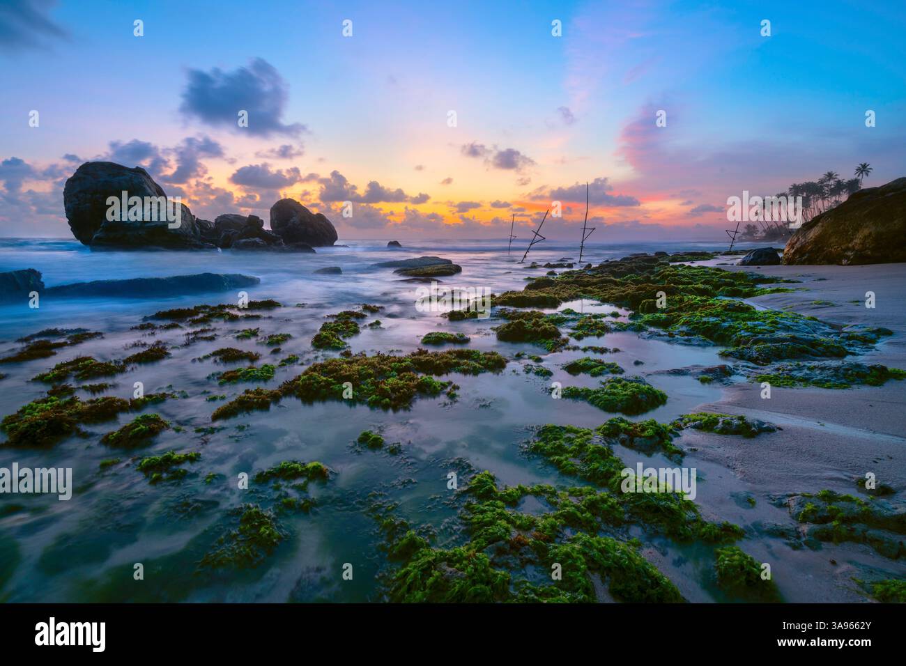 A serene sunset over the tranquil Koggala seascape, capturing the beauty of nature's colors on the Sri Lankan coast Stock Photo