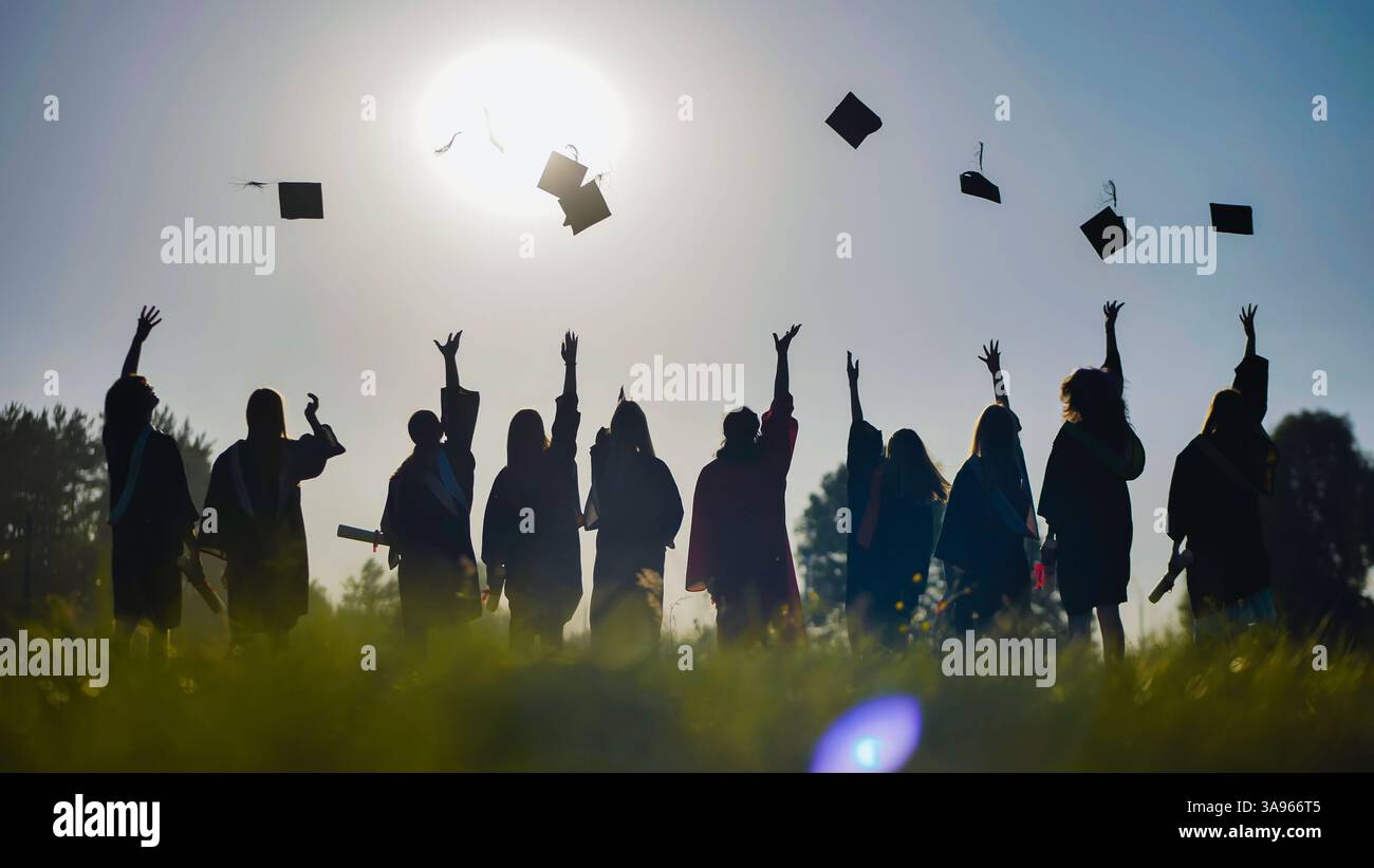 Group of graduates throwing graduation hats in the air Stock Photo - Alamy