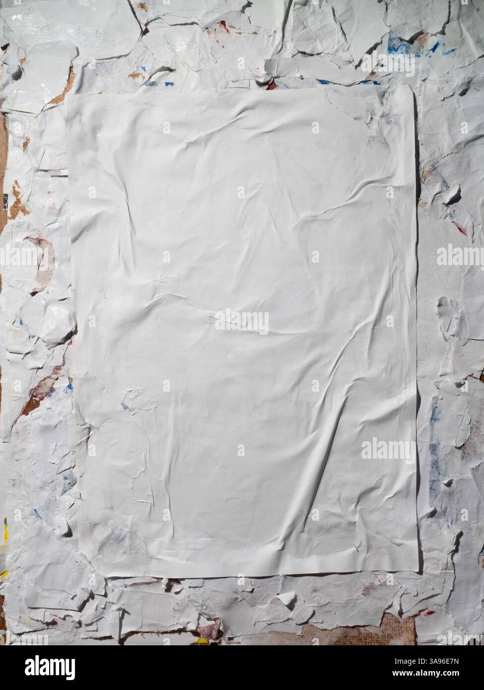 Vertical Wheatpaste poster style texture on a dirty wall Stock Photo