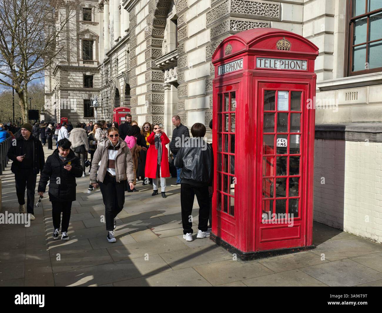 Tourists queuing at an iconic K2 phone box to get their photos taken ...