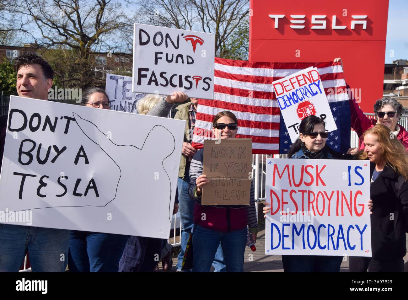 London, UK. 29th March 2025. Protesters gather outside the Tesla Centre ...