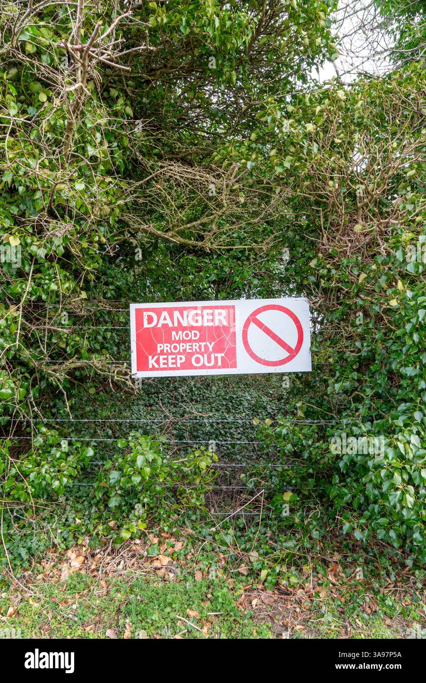 Old danger mod property keep out sign on barbed wire fence Stock Photo ...