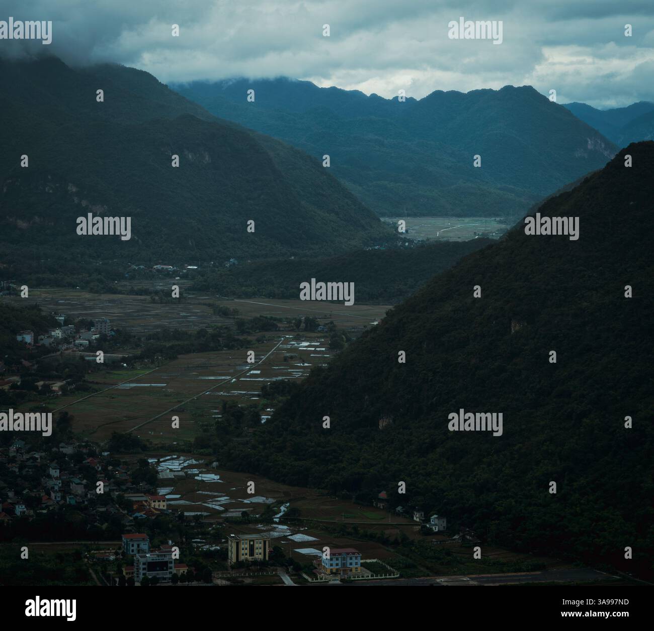 Misty mountains surround a lush valley of Hoa Binh City and Mai Chau, Vietnam Stock Photo