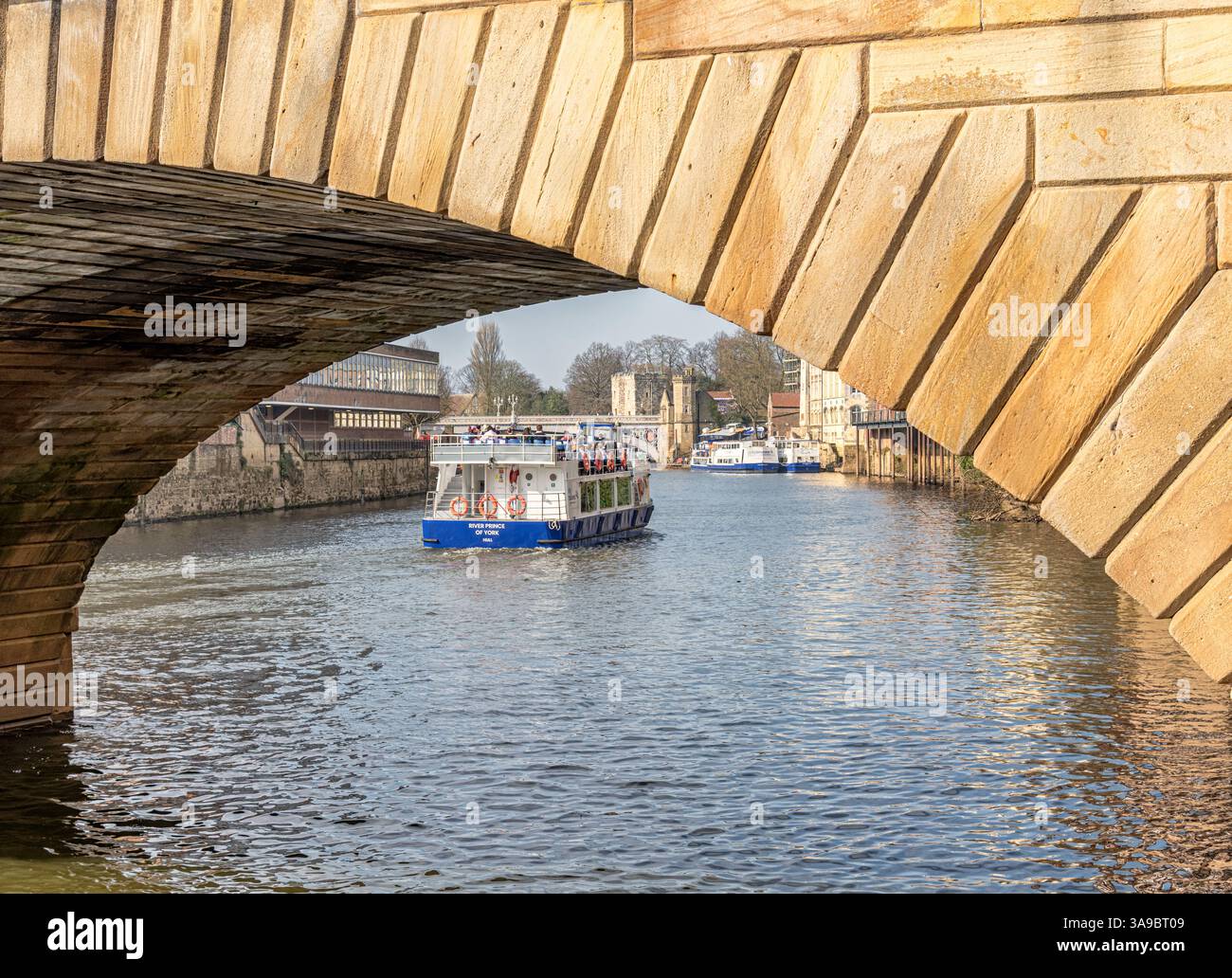 A view through the arch of a 19th Century stone-built bridge. A tour ...