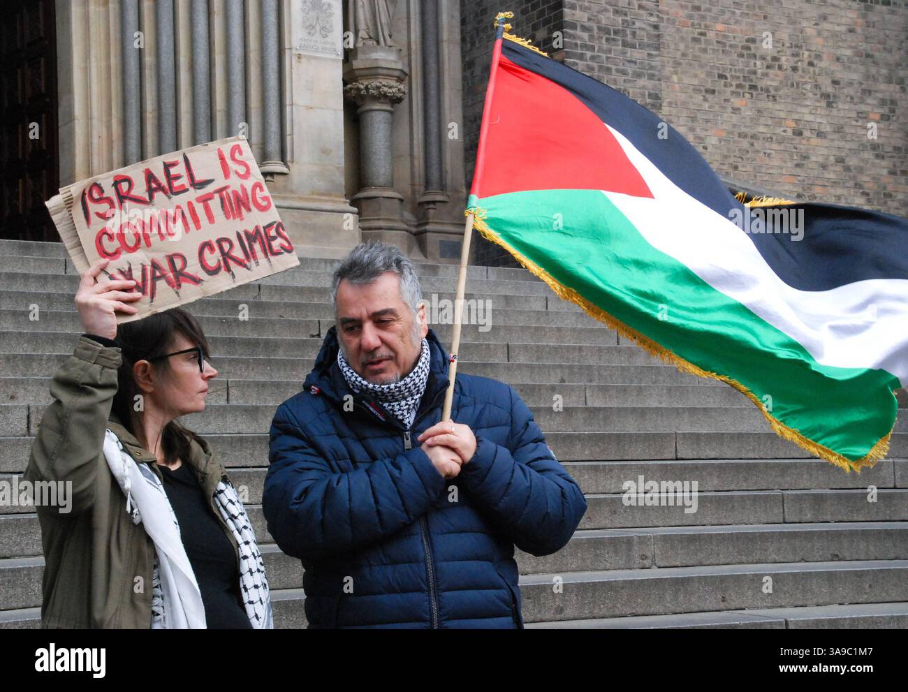 Two Protestors Two protesters stand together during the rally as one holds a ...