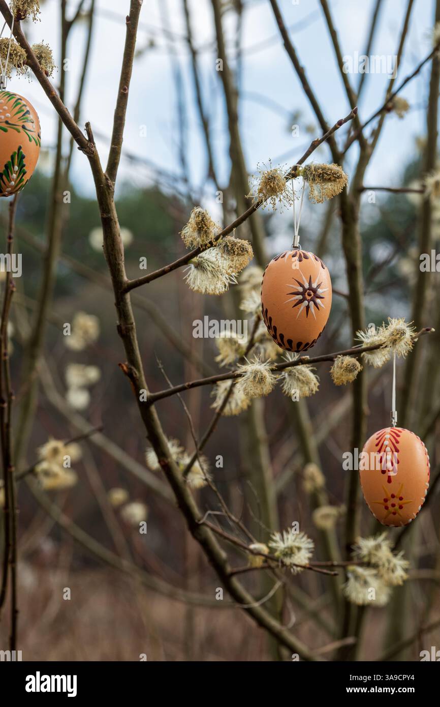 Zoomed-in Three Traditional Wax-Painted Easter Eggs Hanging on Willow Branches Stock Photo